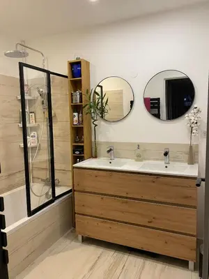 a bathroom with a sink and two mirrors at Les Jades in Le Cannet