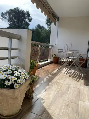 a patio with a planter with flowers on it at Les Jades in Le Cannet