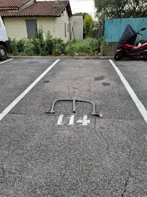 a parking lot with a bike rack in the street at Les Jades in Le Cannet