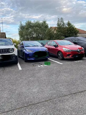 a group of parked cars in a parking lot at Les Jades in Le Cannet