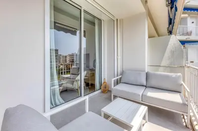 a small balcony with a couch and a table at Dune Croisette - Sea view in Cannes