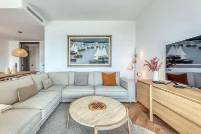 a living room with a couch and a table at Dune Croisette - Sea view in Cannes
