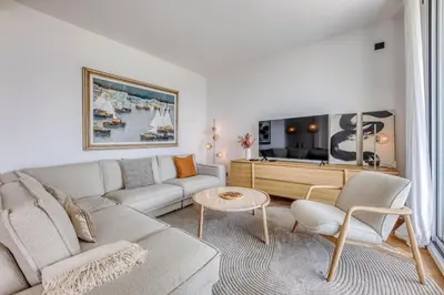 a living room with a couch and a table at Dune Croisette - Sea view in Cannes