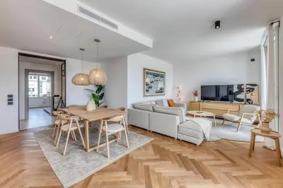 a living room with a couch and a table at Dune Croisette - Sea view in Cannes