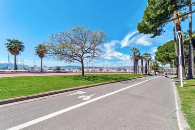a road in a park with trees and grass at Dune Croisette - Sea view in Cannes