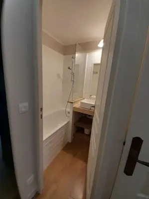 a bathroom with a shower and a sink and a mirror at Vue Mer, Piscine de ouf Votre Oasis à Cannes in Cannes