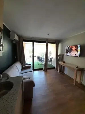 a living room with a couch and a flat screen tv at Vue Mer, Piscine de ouf Votre Oasis à Cannes in Cannes