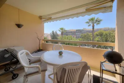a room with a white table and chairs and a balcony at REF 1514 - Apartment with unobstructed view to rent in Cannes