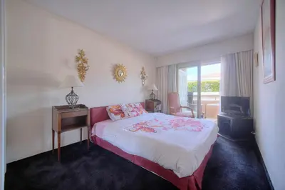 a hotel room with a bed and a desk and a window at REF 1514 - Apartment with unobstructed view to rent in Cannes