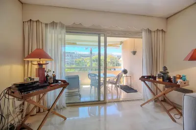 a living room with a table and a dining room at REF 1514 - Apartment with unobstructed view to rent in Cannes