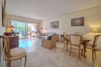 a living room with a table and chairs at REF 1514 - Apartment with unobstructed view to rent in Cannes
