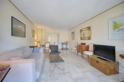 a living room with a couch and a tv at REF 1514 - Apartment with unobstructed view to rent in Cannes