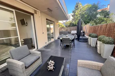 a patio with chairs and a table on a balcony at REF 1921 - Cannes - Apartment for rent in Cannes