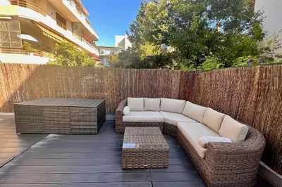 a patio with two wicker couches and a table at REF 1921 - Cannes - Apartment for rent in Cannes