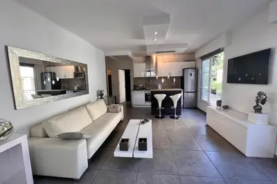 a living room with a white couch and a table at REF 1921 - Cannes - Apartment for rent in Cannes