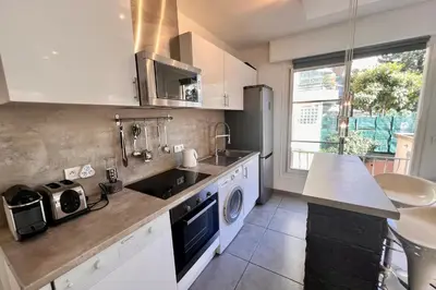a kitchen with a sink and a washing machine at REF 1921 - Cannes - Apartment for rent in Cannes