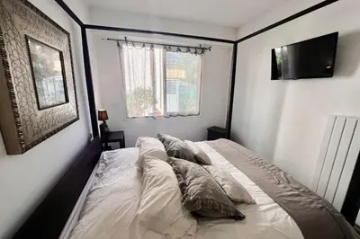 a bedroom with a bed with pillows and a window at REF 1921 - Cannes - Apartment for rent in Cannes