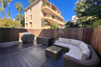 a patio with a couch and chairs on a wooden deck at REF 1921 - Cannes - Apartment for rent in Cannes