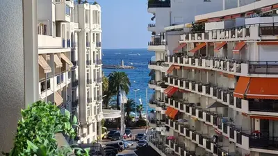 a view of a city with buildings and the ocean at Appartement 2P Terrasse Cannes Croisette Beach 100 meters in Cannes