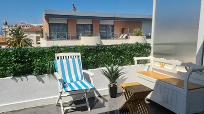 a patio with two chairs and a bench on a balcony at Appartement 2P Terrasse Cannes Croisette Beach 100 meters in Cannes