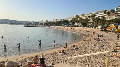 a group of people on a beach in the water at Appartement 2P Terrasse Cannes Croisette Beach 100 meters in Cannes