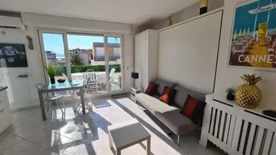a living room with a table and a dining room at Appartement 2P Terrasse Cannes Croisette Beach 100 meters in Cannes