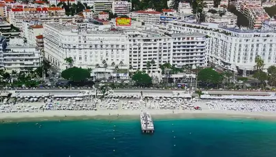 a view of a beach with a boat in the water at Appartement 2P Terrasse Cannes Croisette Beach 100 meters in Cannes