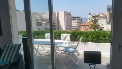 a table and chairs on a balcony with a view at Appartement 2P Terrasse Cannes Croisette Beach 100 meters in Cannes