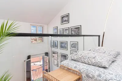 a bedroom with a bed and a shelf on the wall at Le Corail - SCLS Locations in Cannes