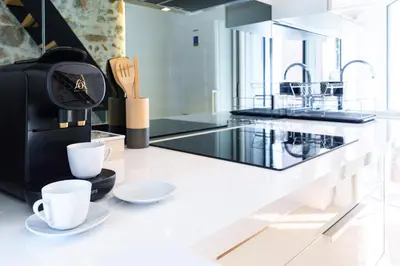 a kitchen with two coffee cups on a counter at Le Corail - SCLS Locations in Cannes