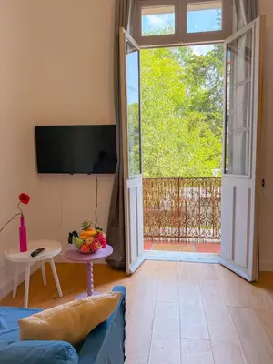 a living room with a blue couch and a sliding glass door at Le Rosy By ApiRent #Balcon #Wifi #Centre-ville in Cannes