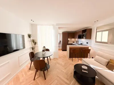 a living room with a couch and a table at Appartement De Luxe 5 Mins à Pied Du Palais Des Festivals by Halldis in Cannes
