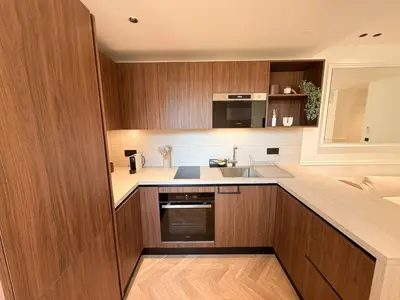 a kitchen with wooden cabinets and a sink at Appartement De Luxe 5 Mins à Pied Du Palais Des Festivals by Halldis in Cannes