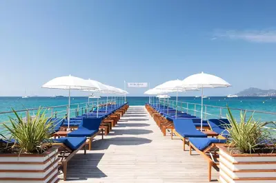 a pier with chairs and umbrellas on the beach at CANNES - à 50m des plages et de la Croisette in Cannes
