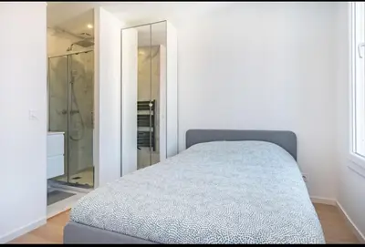 a bedroom with a bed and a walk in shower at Beautiful 2-room apartment on the Croisette in Cannes in Cannes