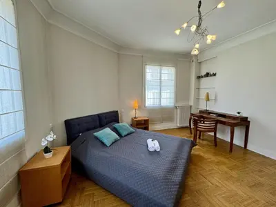 a bedroom with a bed and a desk in it at Grand Palais 4P BOB1309 in Cannes