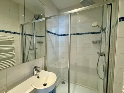 a bathroom with a shower and a sink and a toilet at Grand Palais 4P BOB1309 in Cannes
