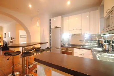 a kitchen with a counter and bar stools in it at Grand Palais 4P BOB1309 in Cannes