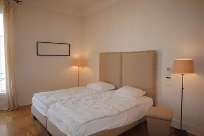 a bedroom with a white bed with two lamps at Grand Palais 4P BOB1309 in Cannes