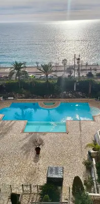 an overhead view of two swimming pools next to the ocean at Pierre Vacances Appt 748 VUE MER in Cannes