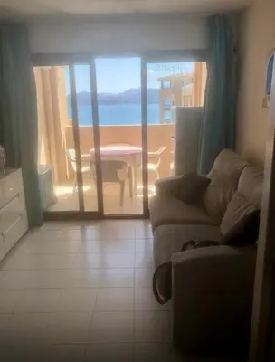 a living room with a couch and a view of the ocean at Pierre Vacances Appt 748 VUE MER in Cannes