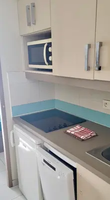a kitchen with a counter top with a microwave at Pierre Vacances Appt 748 VUE MER in Cannes