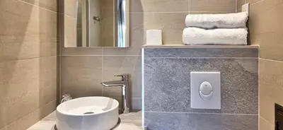 a bathroom with a sink and a toilet and towels at LX147 Studio lumineux centre, confort & autonomie in Cannes