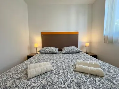 a bedroom with a bed with two pillows on it at Le Clémenceau - SCLS Locations in Cannes