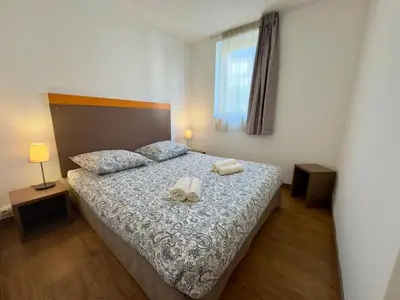 a bedroom with a bed with two towels on it at Le Clémenceau - SCLS Locations in Cannes