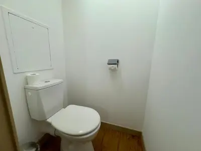 a bathroom with a white toilet and a white wall at Le Clémenceau - SCLS Locations in Cannes