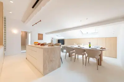 a kitchen and dining room with a table and chairs at 3-Br Attic Duplex Heart of Cannes in Cannes