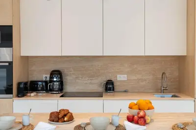 a kitchen with a counter with bowls of fruit on it at 3-Br Attic Duplex Heart of Cannes in Cannes