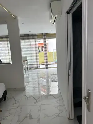 an open door to a room with a tile floor at Normandy in Cannes