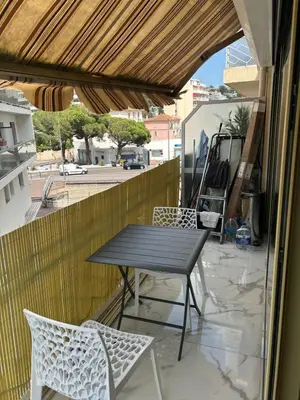 a black table and chairs on a balcony at Normandy in Cannes